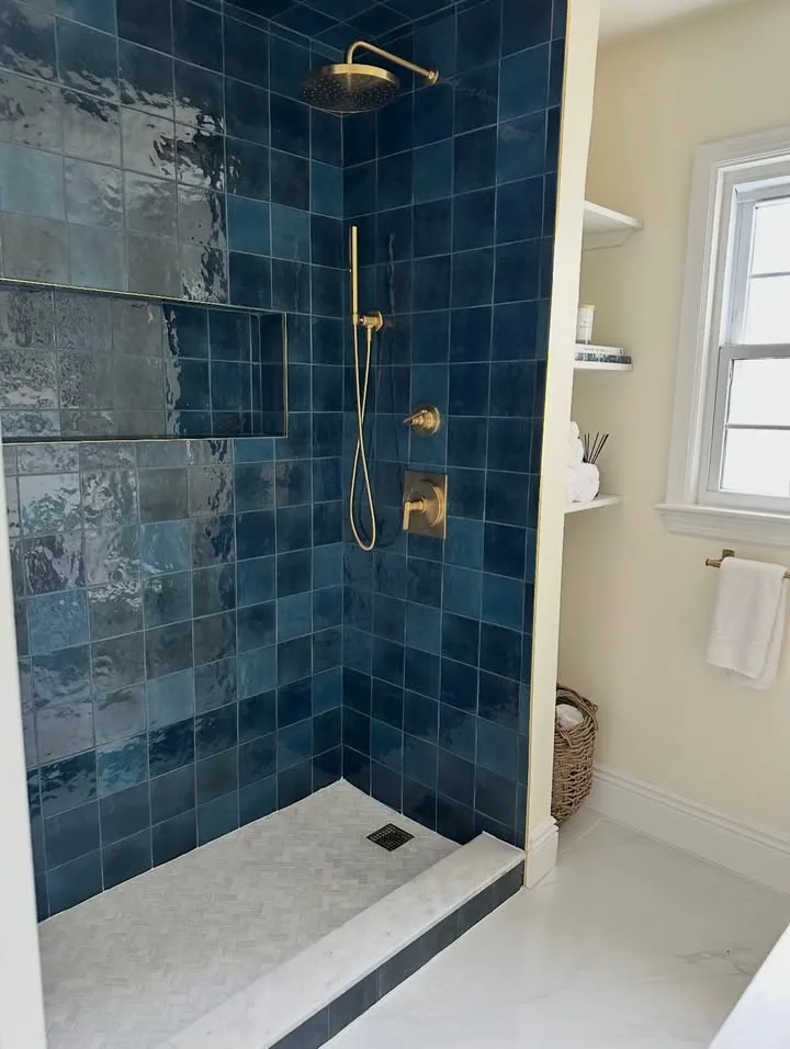 Blue tile shower with brass fixtures