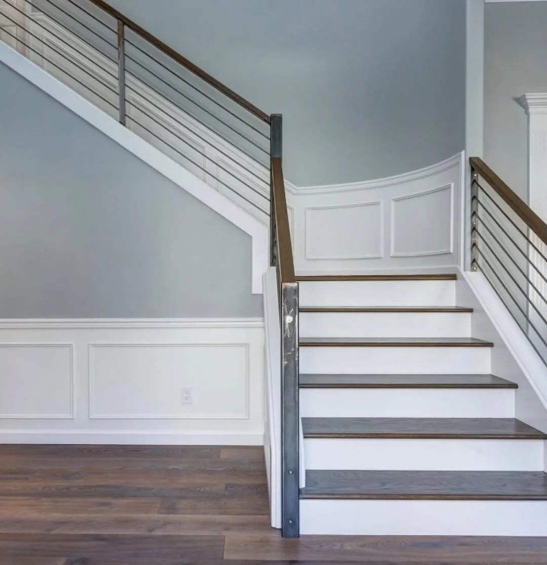 Custom staircase with wainscoting and cable railing