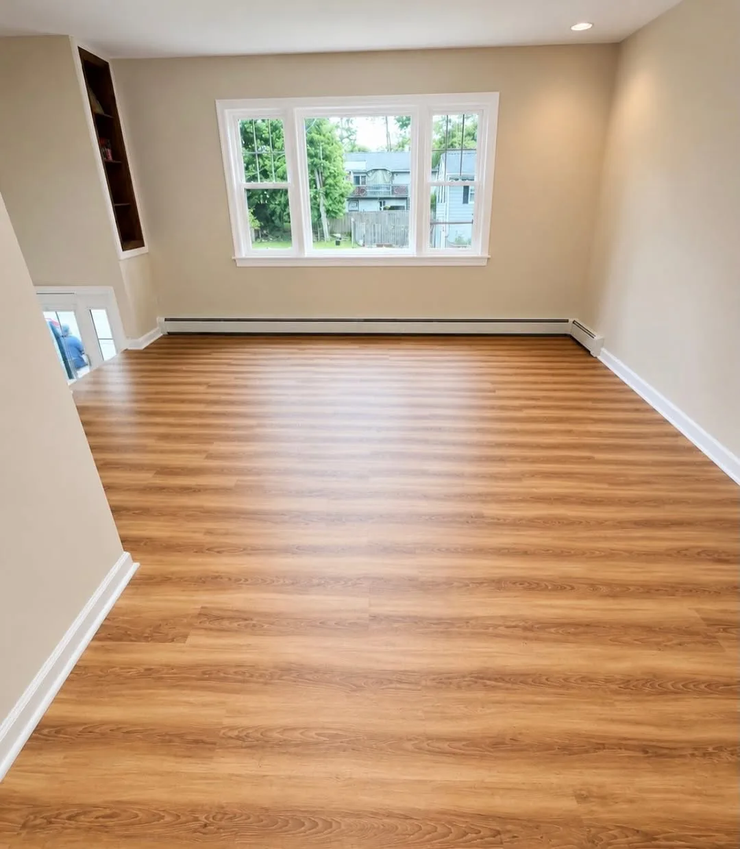 New wood flooring installation in bright living room