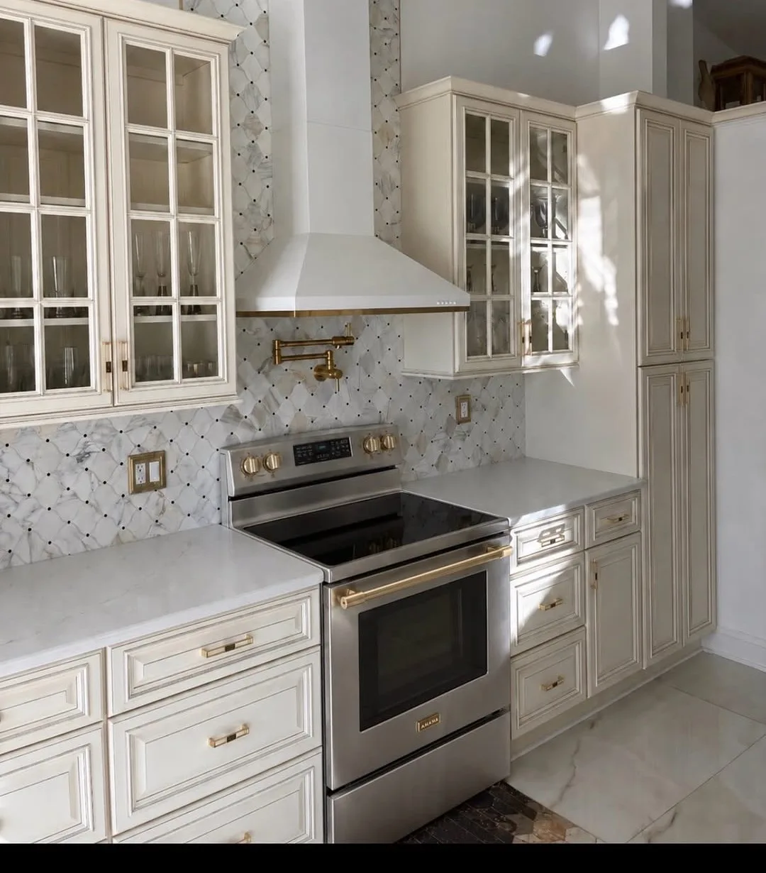 Custom kitchen remodel with cream cabinetry and gold hardware